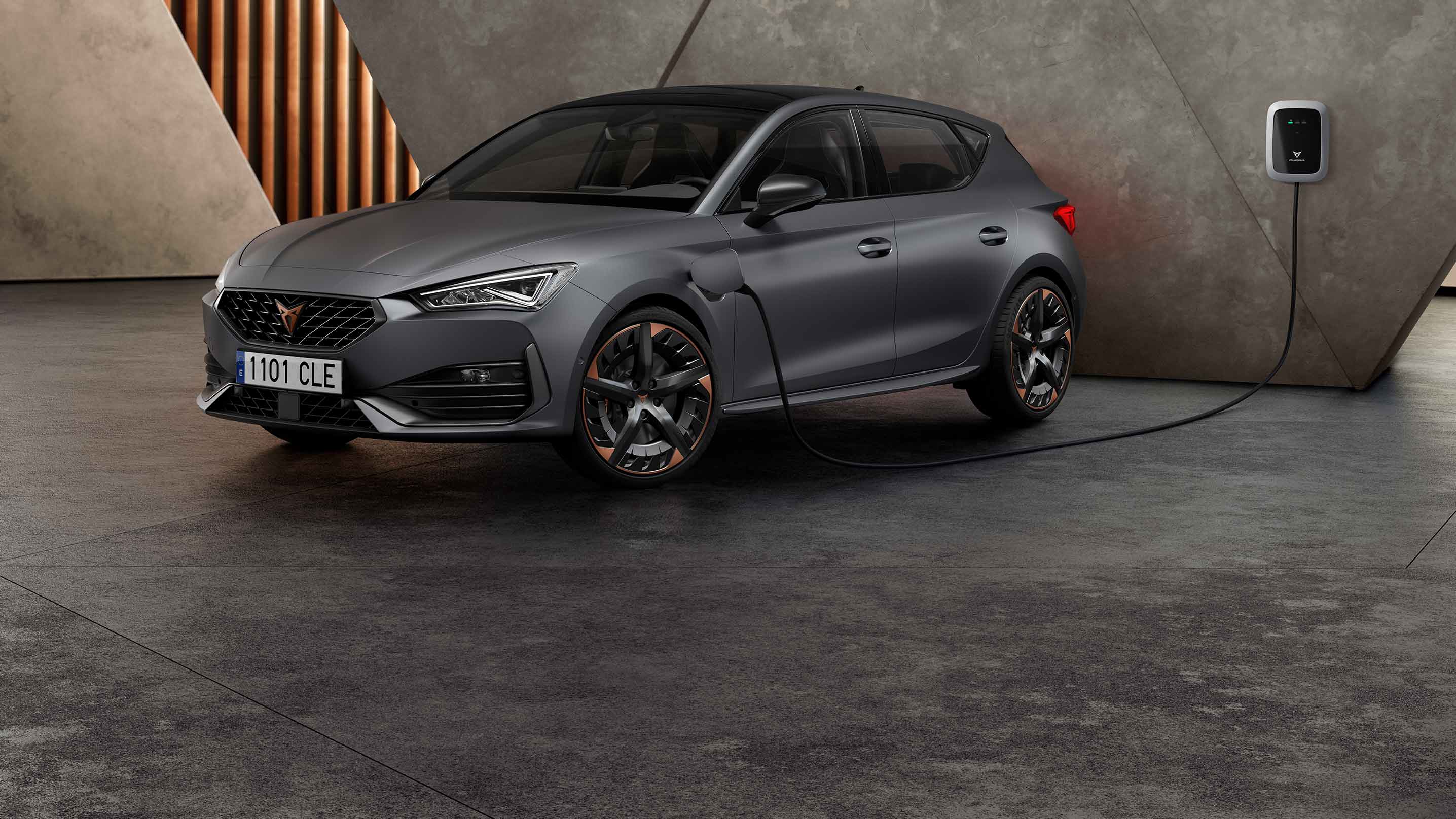new CUPRA Leon ehybrid five door magnetic tech matte compact sports car front side view charging 
